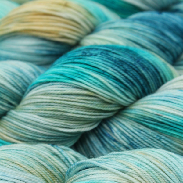 Close-up of skeins of yarn with blue and green hues