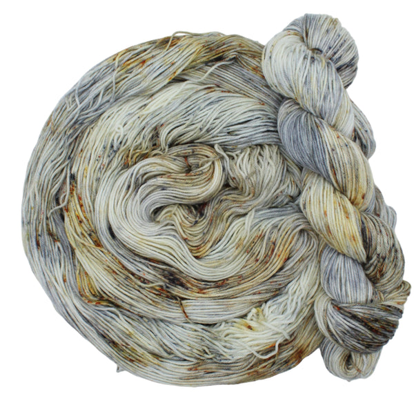 Hand dyed yarn in beige, brown, and grey