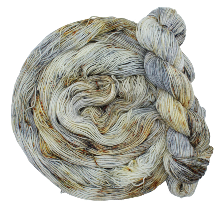 Hand dyed yarn in beige, brown, and grey